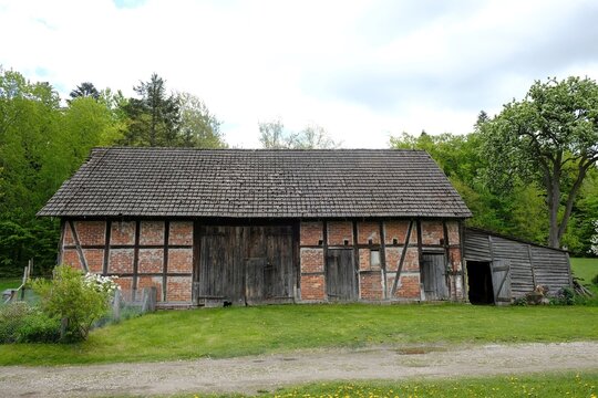 A barn with half-timbered construction in summer scenery on kashubian village, around Bytow, Poland