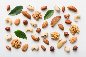Composition of nuts , flat lay - mix hazelnuts, cashews, almonds on table background. healthy eating concepts and food background
