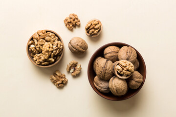 Fresh healthy walnuts in bowl on colored table background. Top view Healthy eating bertholletia concept. Super foods