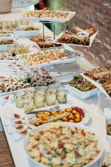Vertical shot of the food and appetizers on the table at a wedding party with blur background