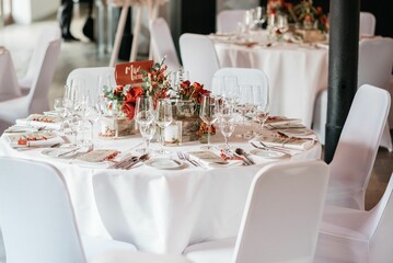 Beautifully decorated table with flowers, plates and glasses ready for a wedding celebration