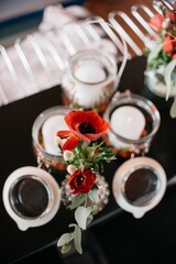 Vertical shot of red flowers in a vase