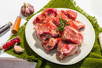 Raw pork loin pieces with ground spices. Fresh meat cut, ingredient for cooking protein food