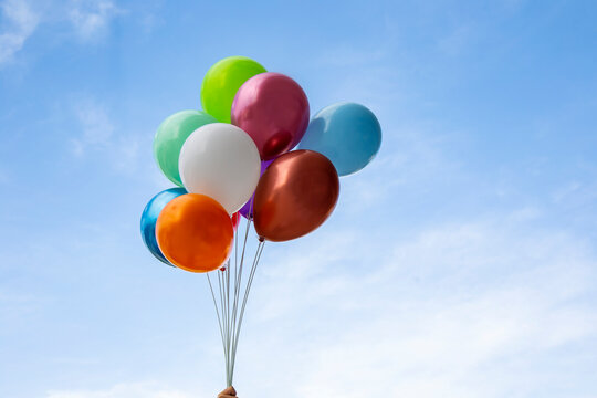 colorful balloons in blue sky, party celebration concept