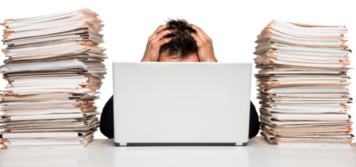 Closeup of an Exhausted Businessman Bheind Laptop with Stack of Folders