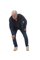 full length front view portrait of a man crouching and looking into the distance on white background