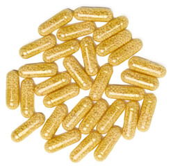 Transparent medical capsules with yellow granules inside on a white background, tablets for...