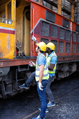 Railroad train maintenance engineer look around discussion with team how to start maintenance work