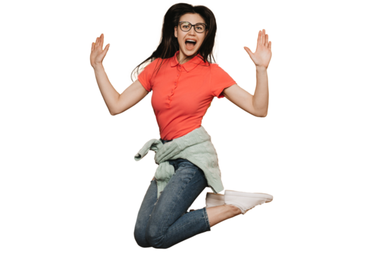Young brunette girl in glasses, wearing red t-shirt, jeans, sweater tied at the waist and white sneakers, jumping high, screaming, raising up hands, enjoying a holiday , over transparent background.