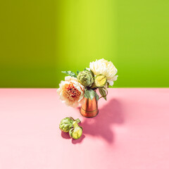 conceptual bouquet: lathe pink peon flowers and green artichokes