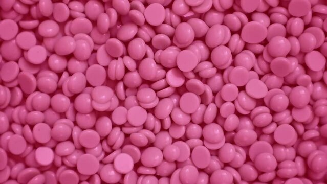 Wax granules for depilation. Background wax texture. Epilation, depilation, removal of unwanted hair. Rotation. View from above. High quality 4k footage