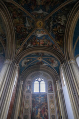 Fototapeta na wymiar Monumental church building in Gothic in neo-romanesque arch style with large ceiling and altar murals and fresco, opulent detailed columns and marble structures