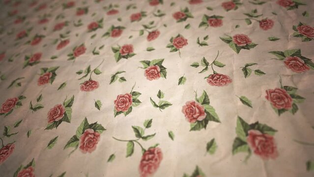 Retro Rose Ornament Wallpaper Background/ 4k motion graphics of a vintage retro old faded wallpaper with printed ornamental roses slowly scrolling with grain texture and depth blur