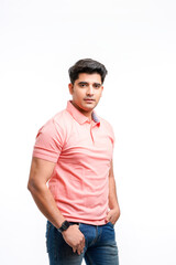 Fototapeta premium Young Indian man wearing basic t-shirt standing and holding hands in pockets.