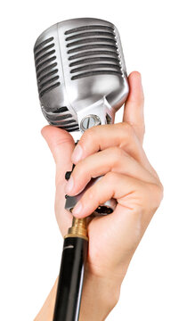 Female hand holding a single retro microphone - isolated image
