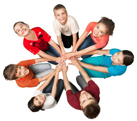 Portrait of Children Sitting Down in Circle Holding Hands
