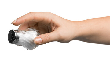 Female hand pouring salt from salt shaker on white background