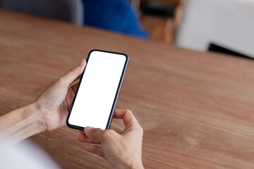 cell phone blank white screen mockup.hand holding texting using mobile on desk at office.background empty space for advertise.work people contact marketing business,technology