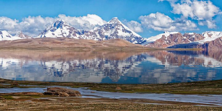 Pik Dankova peak reflecting in water, Tian Shan mountains at the Chinese border, Naryn province, Kyrgyzstan