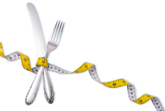 knife and fork wrapped in tape measure, diet and slimming