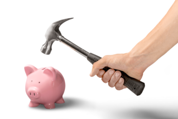 Person smashing piggy bank with hammer on white background