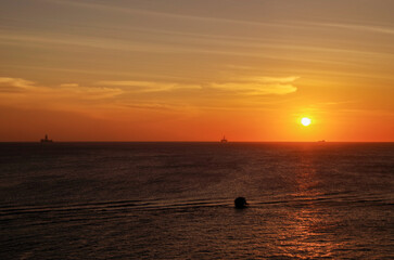 Beautiful dramatic sunset sunrise twilight blue hour seascape scenery over ocean with horizon and clouds cloudscape from cruiseship cruise ship liner sail away from Nassau, Bahamas