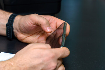 Obraz na płótnie Canvas A smartphone in the hands of a man