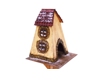 Handmade bird feeder with red roof for birds in a snowy park, isolated on a white background