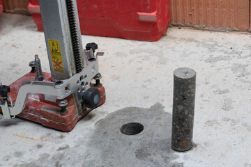 Drilling machine hole in concrete on the floor