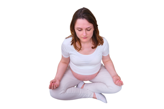 Pregnant woman in the lotus position on the couch in the living room, isolated on a white background