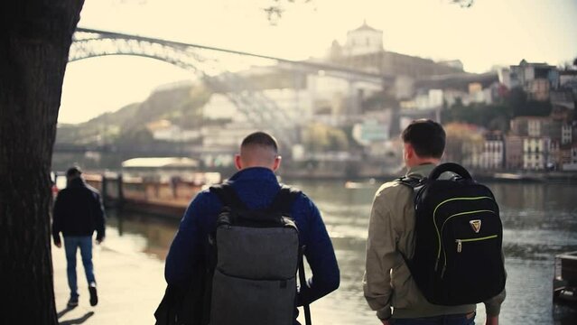Tourist man walking though poor neiborhood narrow streets where poverty can be seen in Oporto, Portugal.