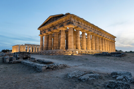 View of Second Temple of Hera and Poseidon temple in Paestum archeological site at sunset, Paestum, Salerno, Campania, Italy.
