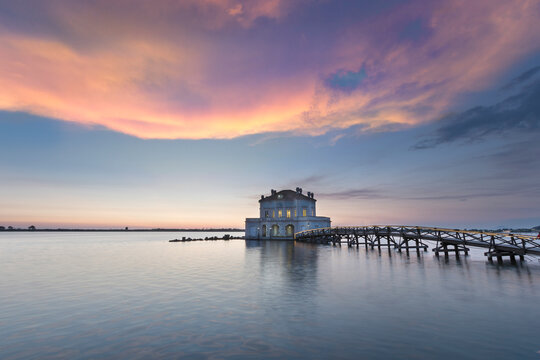 View of Fusaro Lake at sunset and the Casina Vanvitelliana, Bacoli, Naples, Italy.