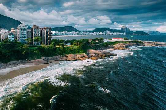 Aerial drone view of Arpoador section of Ipanema Beach with Copacabana and Sugarloaf Mountain visible in the background, Rio de Janeiro, Brazil