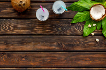 Fresh summer coconut cocktail on a beach board. Vocation background