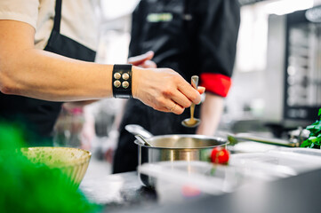 Obraz na płótnie Canvas woman chef cooking seafood soup on restaurant kitchen