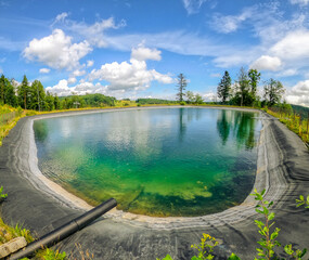 Water reservoir on ski slope in summer, Beskid Mountains, Jaworzyna Krynicka, Poland