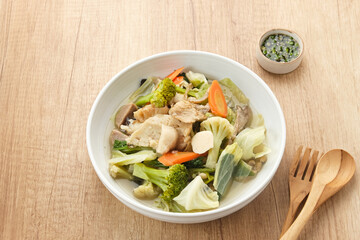 Capcay, stir fried vegetables with shrimp, meatballs and chicken. Served in white plate
