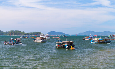 Fototapeta na wymiar Fishing boats are moored in bay of Kota Kinabalu on a sunny day