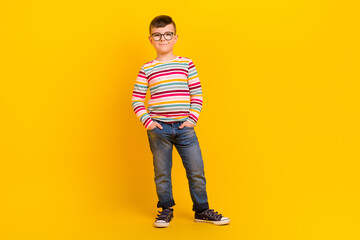 Photo of cheerful glad cute boy wear bright denim outfit promoting kid collection clothes empty space isolated on yellow color background