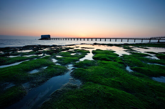 Bembridge Lifeboat Station and shoreline at dawn, Isle of Wight