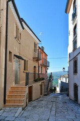 A narrow street among the old houses of Civitacampomarano, a historic town in the state of Molise in Italy.