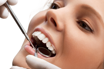 Woman teeth and a dentist mouth mirror on background