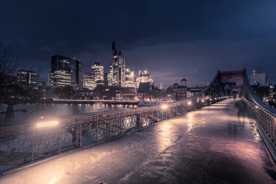 View of Eiserner Steg Bridge and Main River to the skyline at dawn, Frankfurt am Main, Hesse, Germany