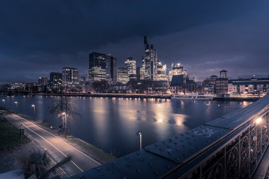 View from Eiserner Steg Bridge across Main River to the skyline of Frankfurt am Main at dawn, Frankfurt am Main, Hesse, Germany