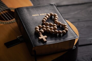 Holy Bible with retro acoustic guitar, music religion concept