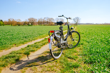 Fototapeta na wymiar Bicycle on a road in rural area in sunny spring day. 