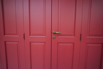 Fototapeta premium The real wooden doors painted red in the National Museum of Bangkok, Thailand are open to the public for tourists to visit and take photos every day.