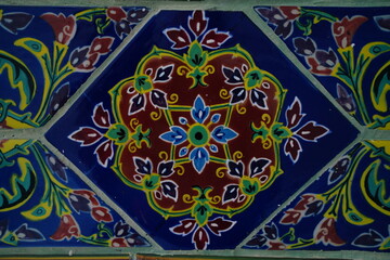 The tiles covering the walls of Wat Ratchabophit, Bangkok, Thailand, are open to the public for tourists to visit and take pictures every day.