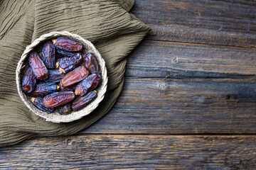 Dried date fruits, Ramadan Kareem, wooden background, copy space, top view.